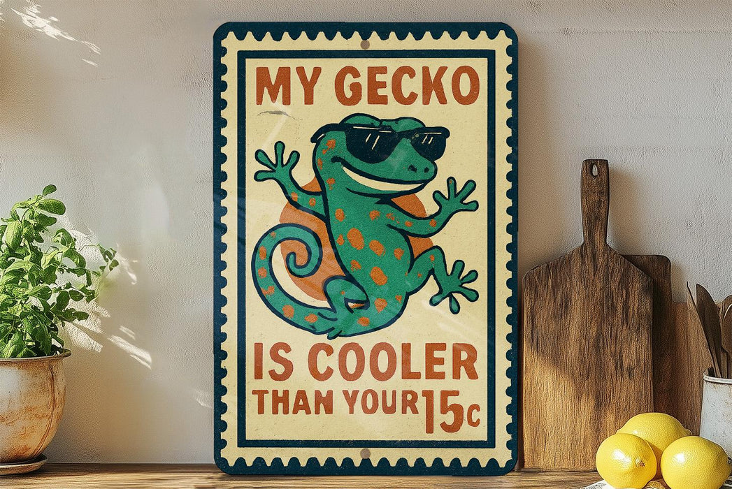 A vintage-style sign featuring a cartoon gecko wearing sunglasses, with the text "MY GECKO IS COOLER THAN YOUR 15¢" displayed prominently.