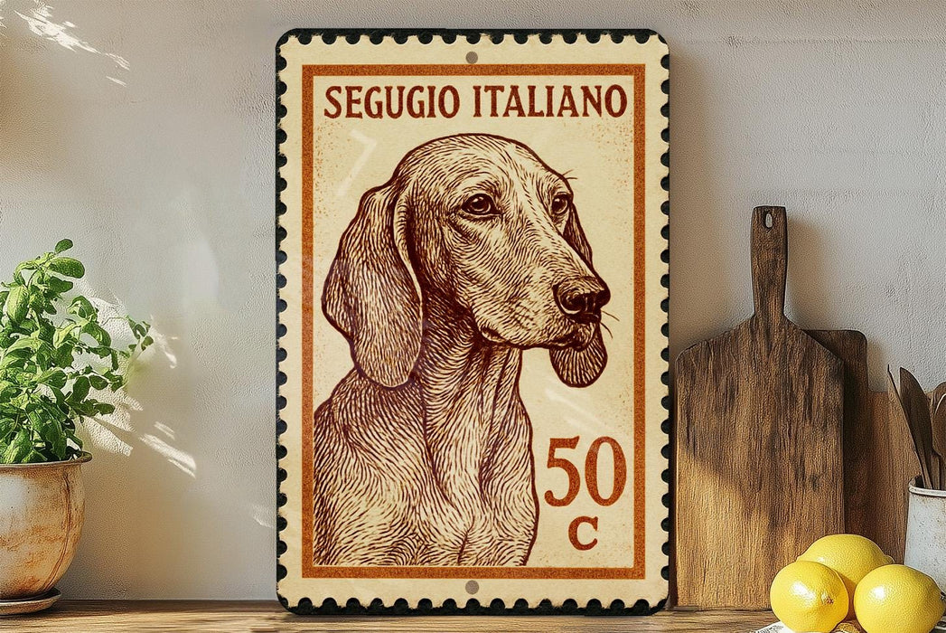 A framed Italian postage stamp featuring a dog's portrait, placed on a wooden surface next to a wooden cutting board and some lemons.