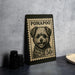 A black and white stamp-like object with a dog illustration on it, placed on a dark surface next to some black camera lenses.