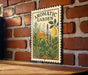 A decorative metal sign with a floral design and the text "AROMATIC GARDEN" is displayed on a brick wall.