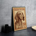 A framed Italian postage stamp featuring a dog's portrait, placed on a table next to some black camera lenses.