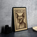 A framed image of a Sphynx cat, a type of hairless cat, is displayed on a table.