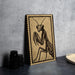 a framed illustration of a praying mantis on a wall.