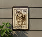 A postage stamp featuring a pomeranian dog, with the text "50c" and "POMSKY" printed on it.