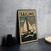 A vintage-style metal sign with a sailboat illustration and the word "SAILING" prominently displayed, placed on a dark surface against a concrete wall.