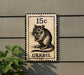 A postage stamp featuring a mouse on a building, with the text "15c" and "GERBIL" printed on it.