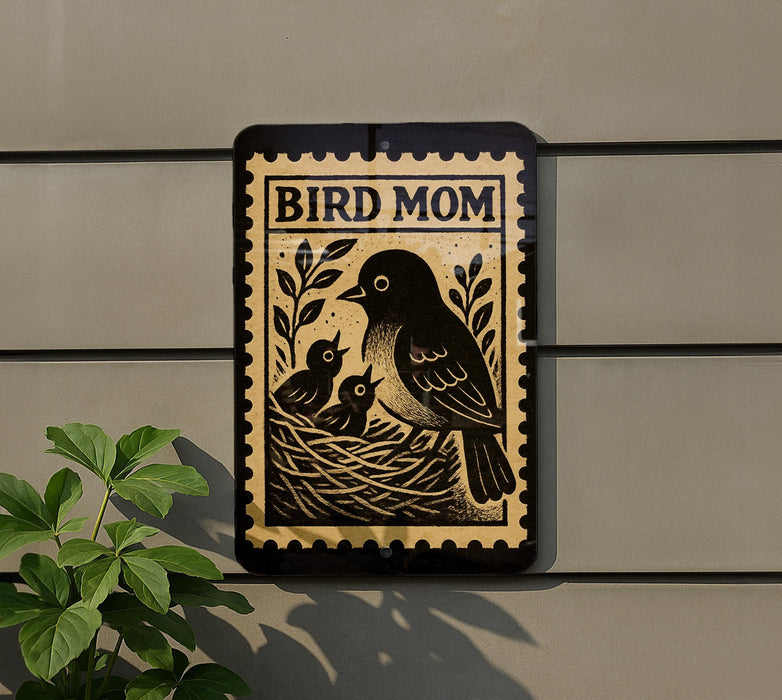 A sign with a bird illustration and the text "BIRD MOM" is displayed on a wall, with a plant visible to the left.