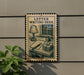 a sign that reads "LETTER WRITING DESK" with an illustration of a desk and various writing supplies.