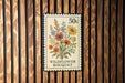 A 50 cent postage stamp featuring a colorful wildflower bouquet.