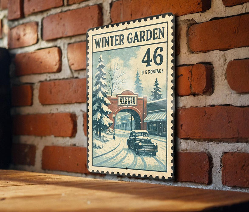 A vintage-style metal sign with a winter garden scene, featuring a car driving through a snowy landscape with a brick building in the background.
