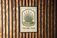 A vintage-style metal sign with a thyme plant illustration is mounted on a wooden wall.