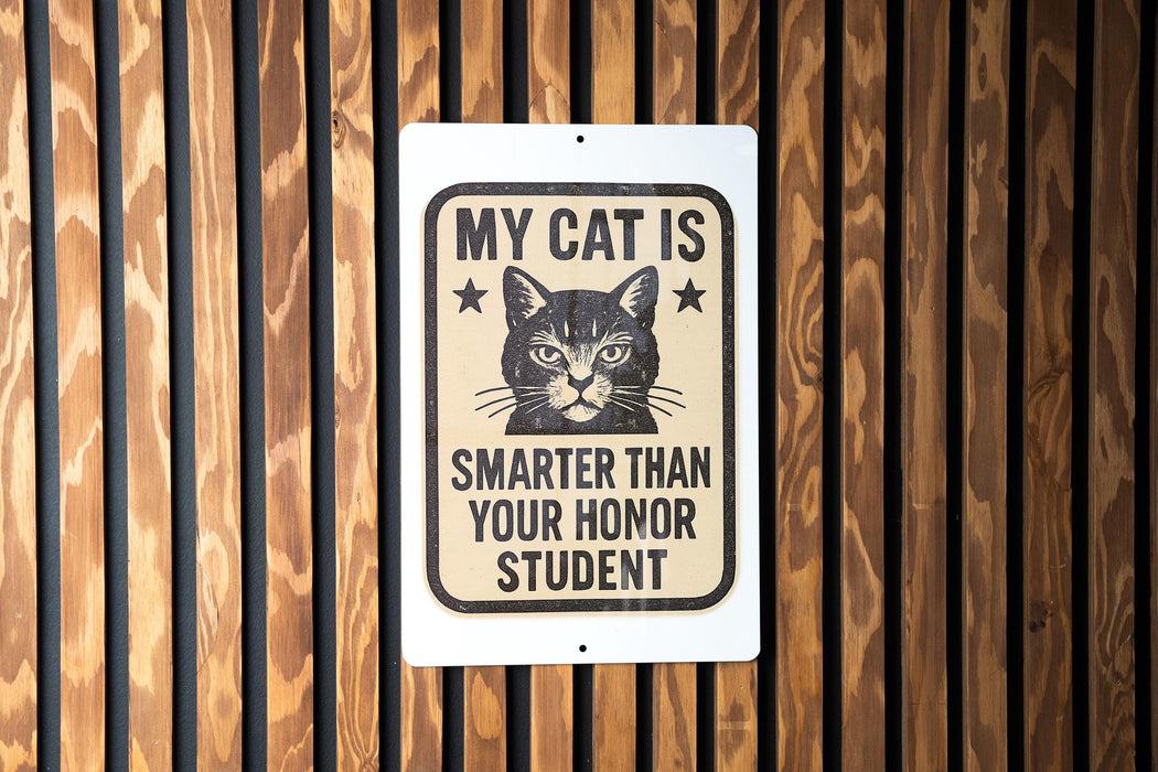 a sign with a cat's face and the text "MY CAT IS SMARTER THAN YOUR Honor STUDENT" on a wooden background.