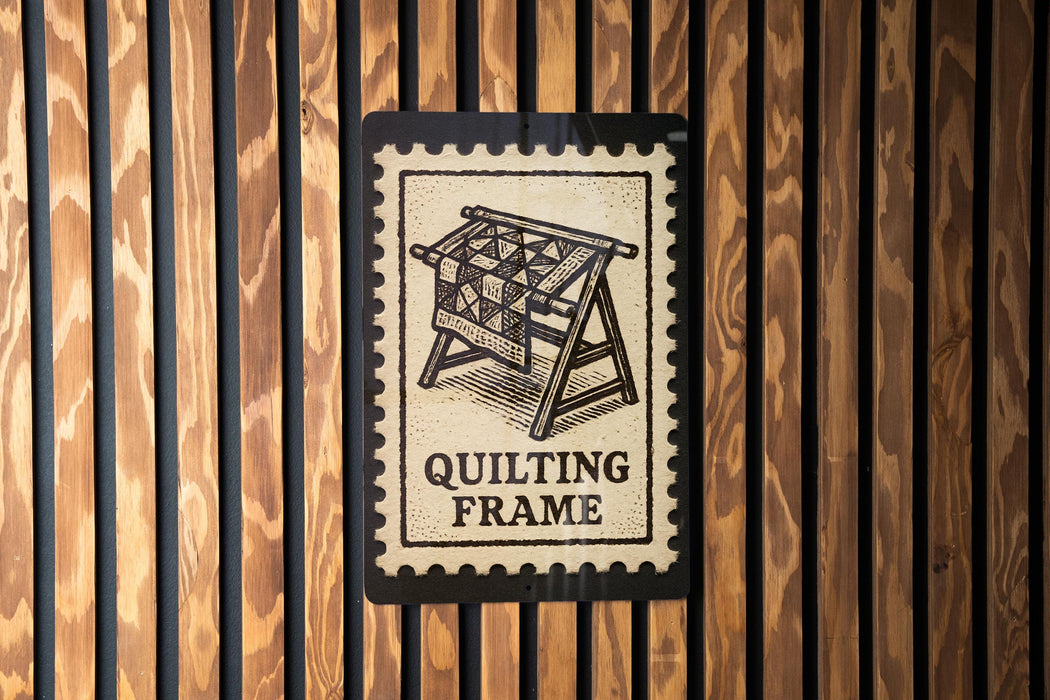 A sign that reads "QUILTING FRAME" is displayed against a wooden background.