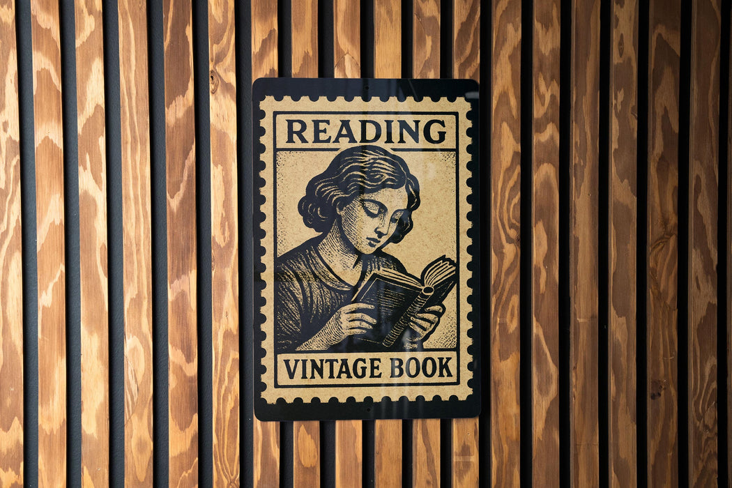 A vintage-style reading sign is displayed on a wooden wall, featuring an illustration of a woman reading a book.