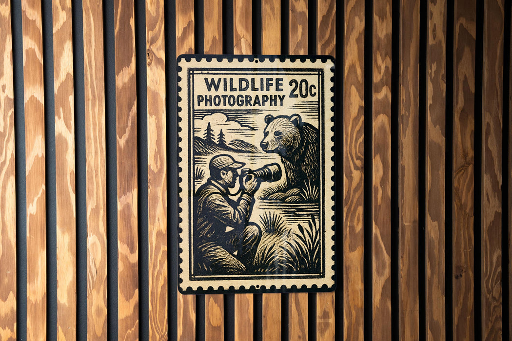 A wildlife photography stamp is displayed on a wooden wall, featuring a person photographing a bear.