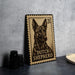 A wooden postcard featuring a dog, specifically a Dutch Shepherd, is displayed on a table.