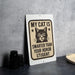A sign with a cat and the text "MY CAT IS SMARTER THAN YOUR Honor STUDENT" is displayed on a table.