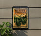A sign with the text "NATURE WATCHING" and an illustration of binoculars, mounted on a wall next to a plant.