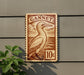 A wooden sign with a bird illustration and the word "GANNET" printed on it, mounted on a wall.
