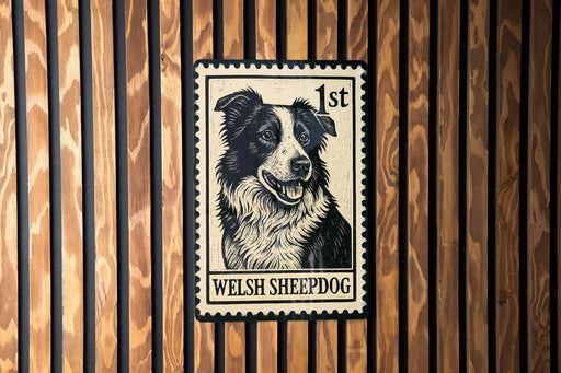 A metal stamp featuring a black and white illustration of a Welsh sheepdog.