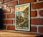 A vintage-style metal sign with a hiker illustration and the text "COASTAL HIKING" is displayed on a brick wall.