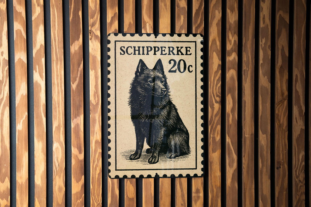 A black and white postage stamp featuring a dog, with the text "SCHIPPERKE 20c" printed on it.