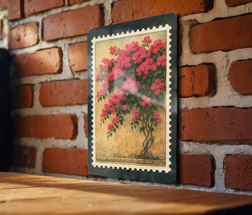 A framed painting of a vibrant floral arrangement is hanging on a brick wall, with a wooden table below it.