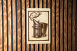 a wooden panel with a metal object, possibly a tool or device, depicted on it.