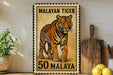 A metal stamp depicting a tiger, with the text "MALAYAN TIGER 50 MALAYA" printed on it.