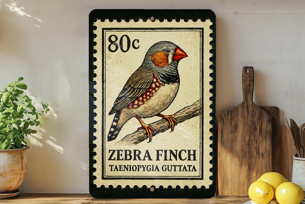 A framed postage stamp featuring a detailed illustration of a zebra finch, with the text "ZEBRA FINCH TAENIOPYGA GUTTATA" printed on it. The stamp is placed on a shelf next to a wooden cutting board and a potted plant.