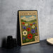 a framed stamp-like artwork depicting a field of colorful flowers, with a vintage-style border and the text "ANEMONE MEadow" printed on it.