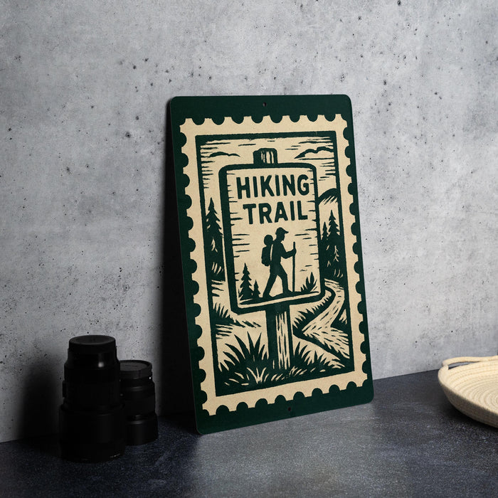 a sign that reads "Hiking Trail" with a silhouette of a hiker and a forest scene.