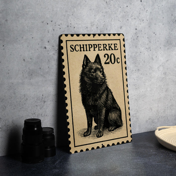 a black and white illustration of a dog on a postage stamp, placed on a table next to some black camera lenses.
