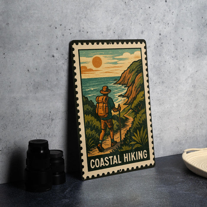 A framed illustration of a hiker on a trail, with the text "COASTAL HIKING" below the image.