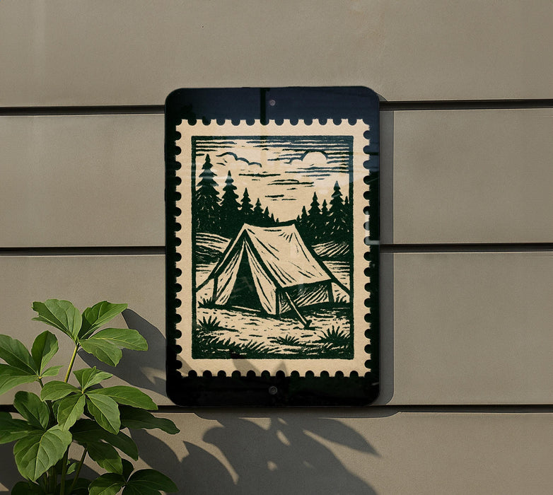 a green and white stamp-like design on a wall, depicting a tent in a forest setting.