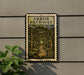 a sign for the "Arbor Pathway" hanging on a wall, with a plant to the left of the sign.