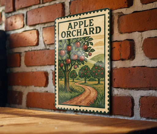 A vintage-style metal sign with the text "APPLE ORCHARD" and an illustration of an apple tree with apples hanging from its branches.