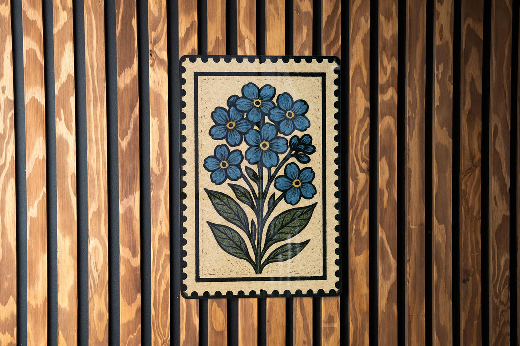 a decorative tile with a floral design, mounted on a wooden wall.