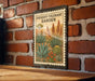 a metal sign with a vintage-style illustration of a desert garden, mounted on a brick wall.