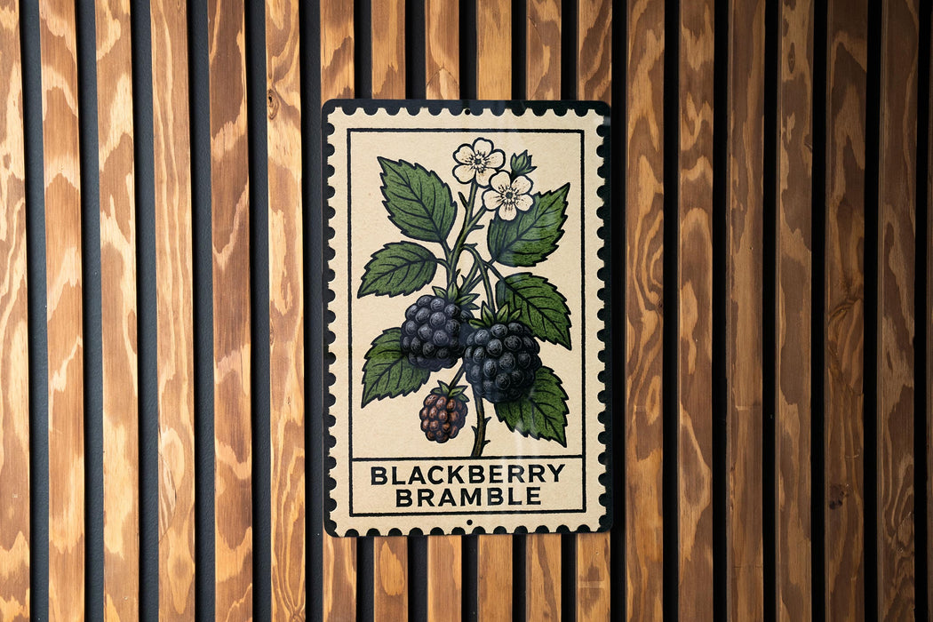 A postage stamp-like illustration of a berry plant with blackberries and white flowers is displayed on a wooden wall.