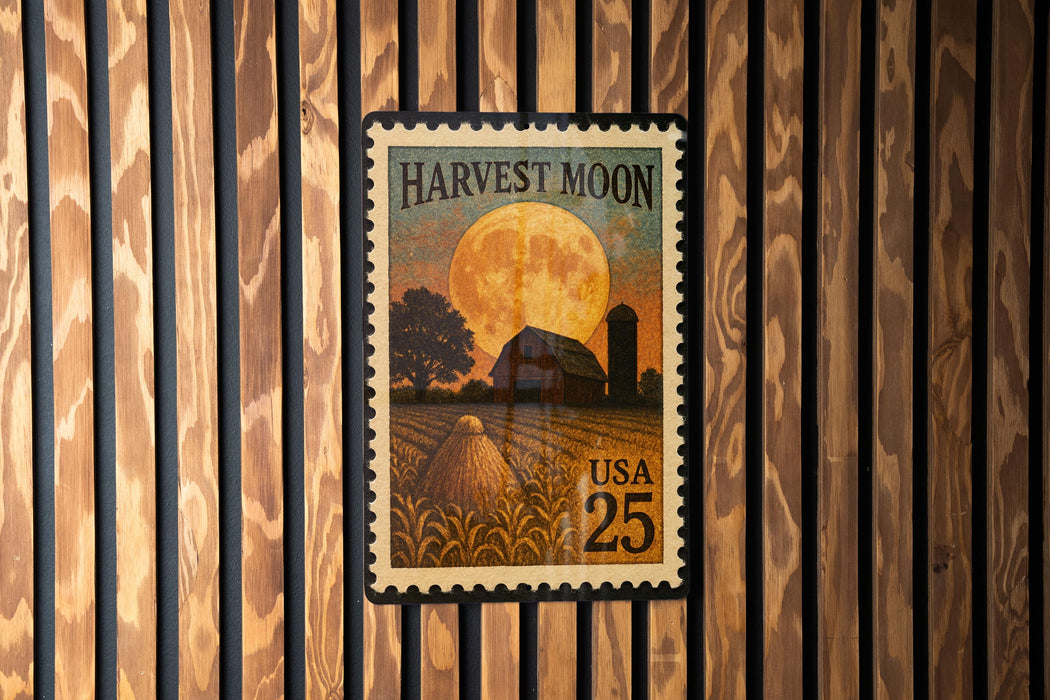 A United States postage stamp depicting a rural scene with a full moon, a barn, and a field of crops.