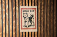 A sign with the name "KISHU KEN" printed on it, featuring an illustration of a dog.