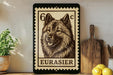 A framed image of a dog, specifically a Belgian Shepherd, is displayed on a shelf next to a wooden cutting board and some lemons.