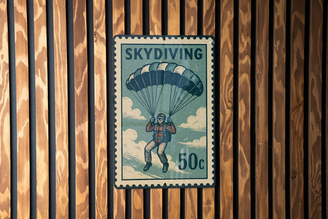 A vintage postage stamp featuring a skydiving scene with a parachutist and the text "SKydiving 50c".