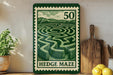 A green and white metal sign with a maze design, mounted on a wall next to a wooden cutting board and some potted plants.