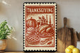 A Thanksgiving-themed metal sign with illustrations of a turkey, pumpkin, pie, and other traditional Thanksgiving dishes, along with candles and other festive elements, is displayed on a shelf next to a potted plant and kitchen utensils.