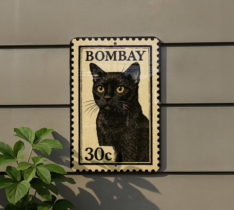 A black cat with yellow eyes is depicted on a stamp-like sign, mounted on a wall.