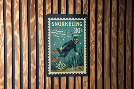 A poster of a snorkeling scene with a person wearing a snorkel and fins, surrounded by underwater plants and coral, is displayed on a wooden wall.