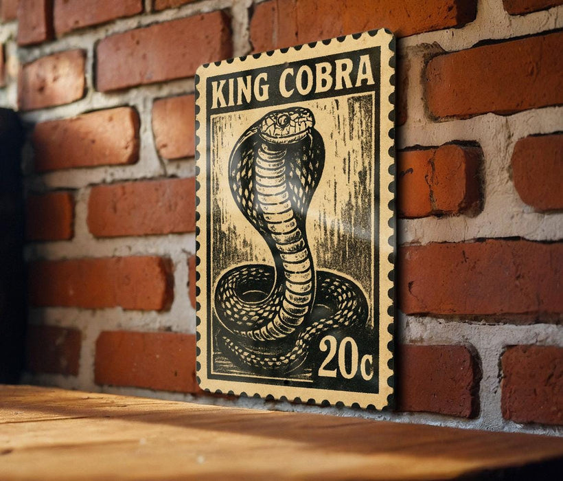 A black and white illustration of a cobra on a 20 cent stamp is displayed on a brick wall.