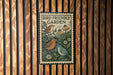 A metal sign with a bird illustration and the text "Bird-Friendly Garden" is displayed on a wooden slatted wall.
